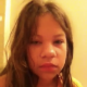 A girl video-records her facial expressions as she takes a shit while sitting on a toilet. Pooping sounds are audible, and then she shows us her finished product.